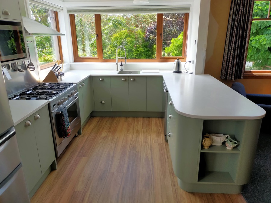 New kitchen installation with sage cabinetry and stone benchtop