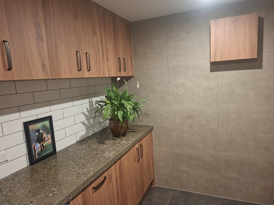 Walk-in scullery with pull-out drawers and timber cabinetry